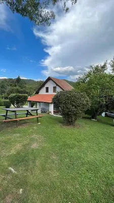 a picnic table in front of a house at Complejo Villa General Belgrano in Villa General Belgrano