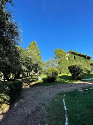 a gravel road leading to an old stone house at Complejo Villa General Belgrano in Villa General Belgrano