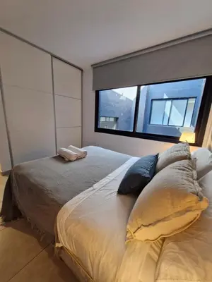 a bedroom with a large bed and a window at Departamento VCP Costanera in Villa Carlos Paz