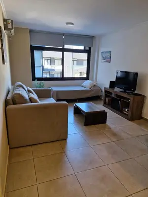 a living room with a couch and a tv at Departamento VCP Costanera in Villa Carlos Paz