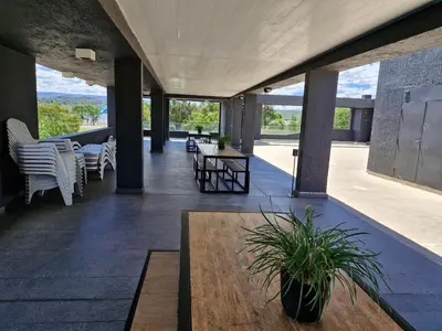 a room with a table and chairs on a patio at Departamento VCP Costanera in Villa Carlos Paz
