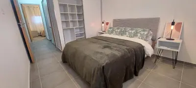 a bedroom with a bed and a table with a lamp at Hermoso departamento a estrenar 3 in Alta Gracia