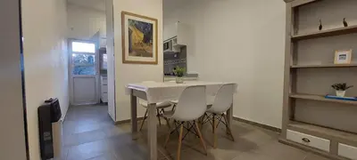 a kitchen and dining room with a table and chairs at Hermoso departamento a estrenar 3 in Alta Gracia