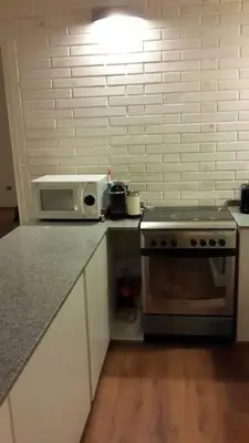 a kitchen with a stove and a microwave on a counter at Dique Los Molinos Exclusiva casa vista al lago in Cordoba