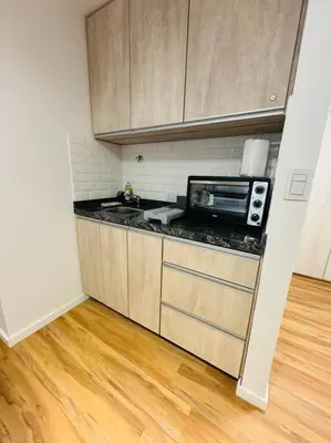 a kitchen with a microwave and a counter top at Departamento ideal en Nueva Córdoba SS5 in Cordoba