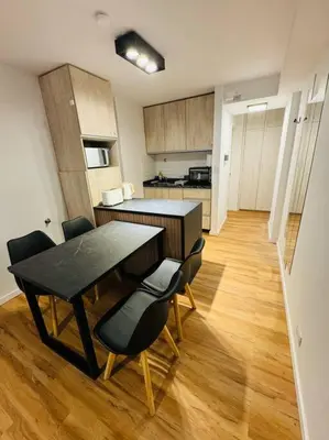 a kitchen with a table and chairs in a room at Departamento ideal en Nueva Córdoba SS5 in Cordoba