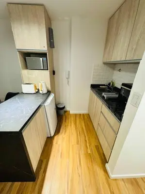 a small kitchen with a black and white counter top at Departamento ideal en Nueva Córdoba SS5 in Cordoba