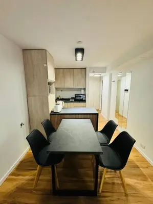 a kitchen with a table and chairs in a room at Departamento ideal en Nueva Córdoba SS5 in Cordoba