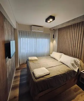 a bedroom with a large bed with towels on it at Departamento tranquilo y luminoso en Nva Cba SS7 in Cordoba