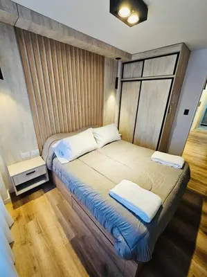 a bedroom with a bed with two pillows on it at Departamento tranquilo y luminoso en Nva Cba SS7 in Cordoba