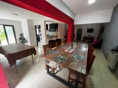 a dining room and kitchen with a table and chairs at Apart Pilar in Pilar