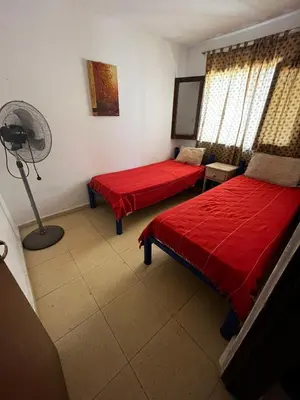 a room with two beds and a fan in it at Apart Pilar in Pilar