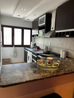 a kitchen counter with a tray of food on it at Apart Pilar in Pilar