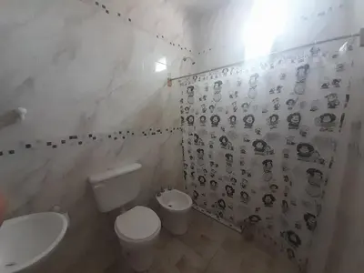 a bathroom with a toilet and a sink at CapFer Alojamiento in Alta Gracia