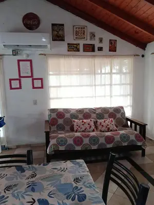 a living room with a couch and a table at Cabaña Alma Serrana in Bialet Massé
