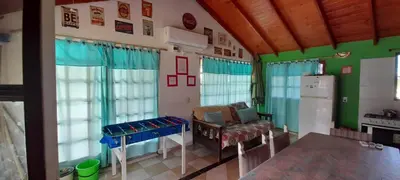 a kitchen with a table and a refrigerator in a room at Cabaña Alma Serrana in Bialet Massé