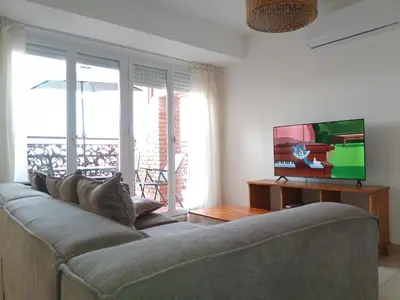 a living room with a couch and a flat screen tv at duplex13b in Cordoba