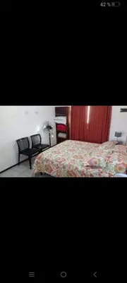 a bedroom with a bed and a red curtain at Traslavista alojamiento de ensueño in Villa de Las Rosas
