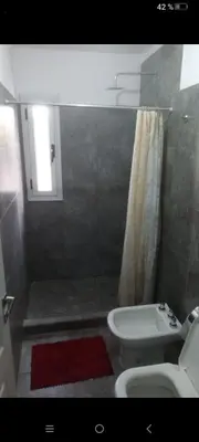 a bathroom with a white toilet and a shower at Traslavista alojamiento de ensueño in Villa de Las Rosas