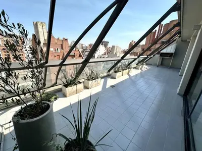 a balcony with potted plants on a building at Departamento para 6 personas in Cordoba