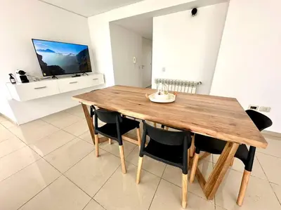 a wooden table and chairs in a living room at Departamento para 6 personas in Cordoba