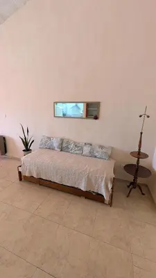 a bedroom with a bed and a table and a window at Alojamiento El Caracol in Villa Carlos Paz