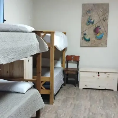 a bedroom with two bunk beds and a desk at Dormis Clave de Sol in Villa Ciudad Parque