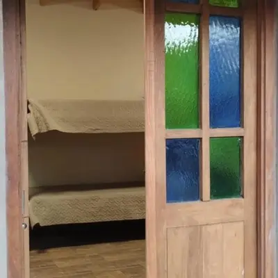 a door leading into a room with a bunk bed at Dormis Clave de Sol in Villa Ciudad Parque