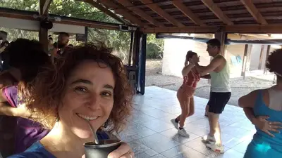a woman with a straw in her cup of coffee at Dormis Clave de Sol in Villa Ciudad Parque