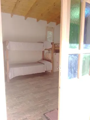 a room with two bunk beds and a window at Dormis Clave de Sol in Villa Ciudad Parque