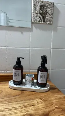 two bottles of soap on a plate on a table at CASA de Campo EL LULY in La Bolsa