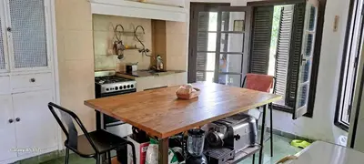 a kitchen with a wooden table and chairs in it at CASA de Campo EL LULY in La Bolsa