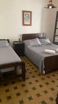 a bedroom with two twin beds and a lamp at CASA de Campo EL LULY in La Bolsa