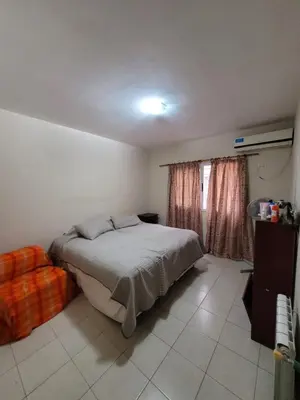 a bedroom with a large bed and a window at Departamento en Villa Carlos Paz in Villa Carlos Paz