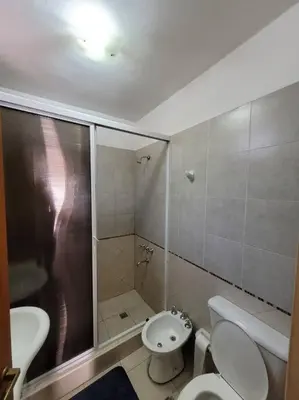 a bathroom with a shower and a toilet and a sink at Departamento en Villa Carlos Paz in Villa Carlos Paz