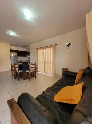 a living room with a couch and a table at Departamento en Villa Carlos Paz in Villa Carlos Paz