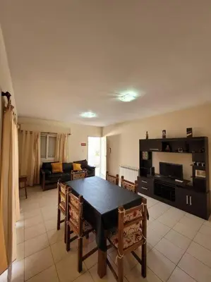 a living room with a table and a couch at Departamento en Villa Carlos Paz in Villa Carlos Paz