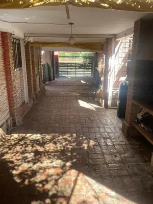 an empty hallway of a building with the sun shining at Departamentos Altos del Puchuqui in Santa Rosa de Calamuchita