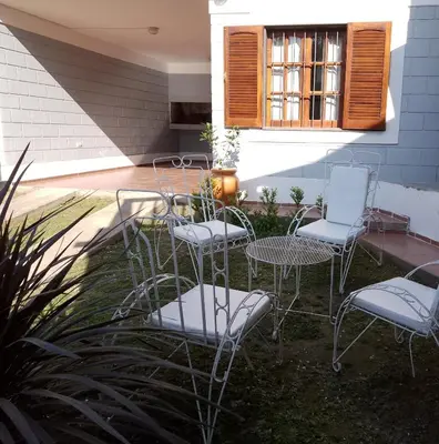a group of chairs and tables on a patio at El Remanso in Villa Independencia