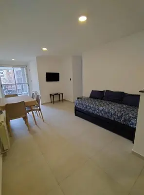 a living room with a bed and a table and chairs at Obispo Salguero Apartamento especial in Cordoba