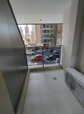 a room with a balcony with a view of a parking lot at Obispo Salguero Apartamento especial in Cordoba