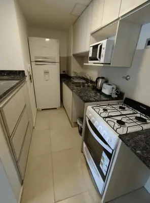 a kitchen with a stove and a white refrigerator at Obispo Salguero Apartamento especial in Cordoba