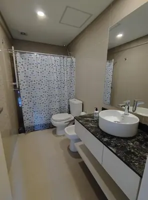 a bathroom with a sink and a toilet and a mirror at Obispo Salguero Apartamento especial in Cordoba