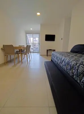 a bedroom with a bed and a table and a television at Obispo Salguero Apartamento especial in Cordoba