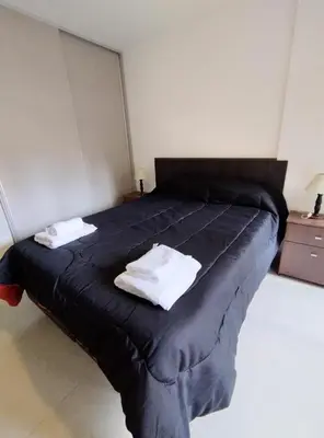 a bed with two pillows on it in a room at Obispo Salguero Apartamento especial in Cordoba