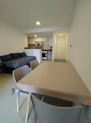 a table and chairs in a room with a kitchen at Obispo Salguero Apartamento especial in Cordoba
