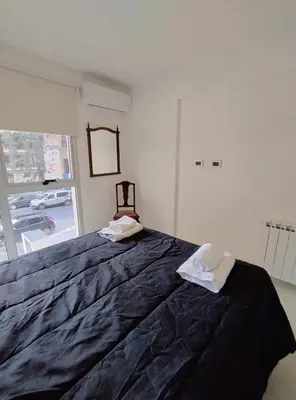 a bedroom with a large bed with two towels on it at Obispo Salguero Apartamento especial in Cordoba