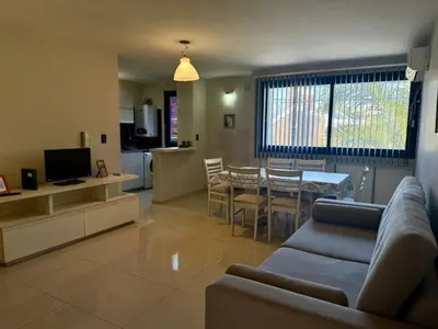 a living room with a couch and a dining room at ARECAS Carlos Paz in Villa Carlos Paz