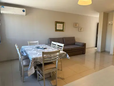 a dining room with a table and a couch at ARECAS Carlos Paz in Villa Carlos Paz