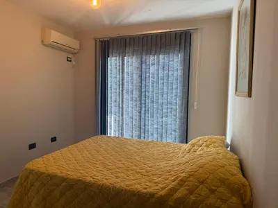 a bedroom with a bed with a large window at ARECAS Carlos Paz in Villa Carlos Paz